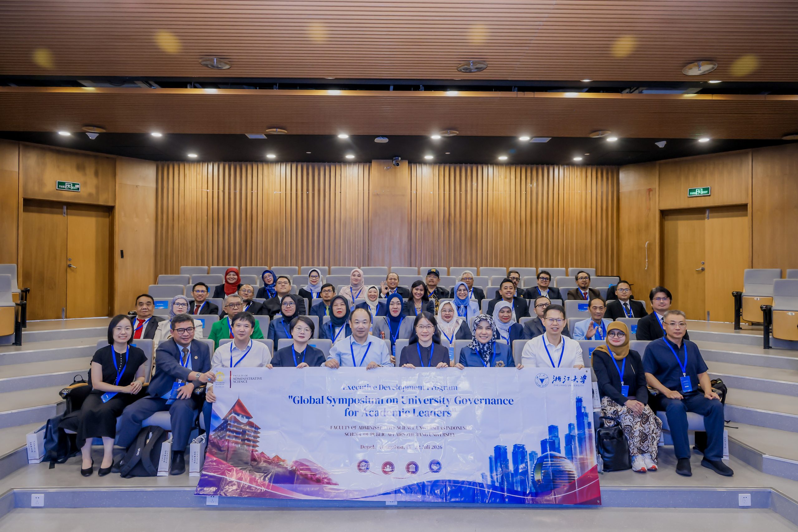 Foto bersama delegasi FIA UI dan Zhejiang University dengan banner Global Symposium on University Governance for Academic Leaders